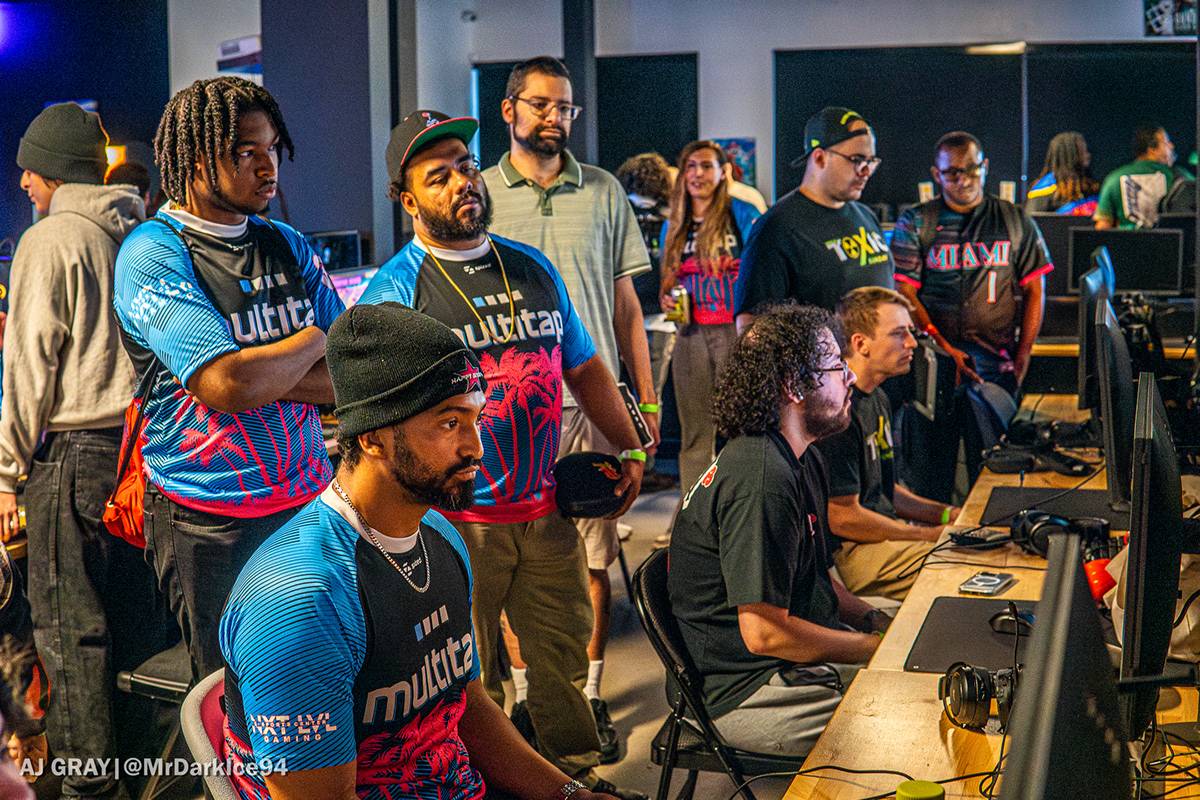 Multitap players and teammates gathered around a tournament setup